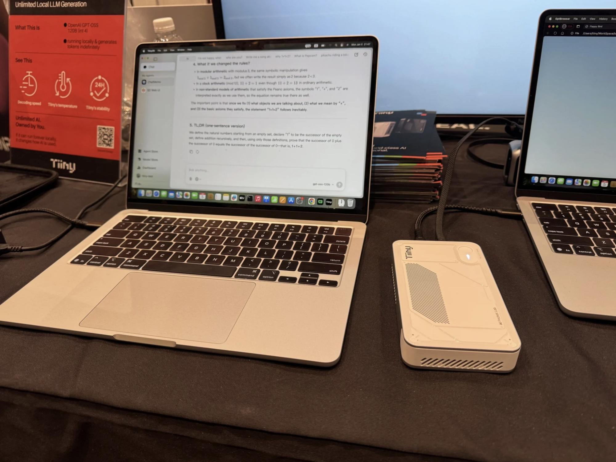 Tiiny AI Pocket Lab on a table next to a laptop at CES 2026