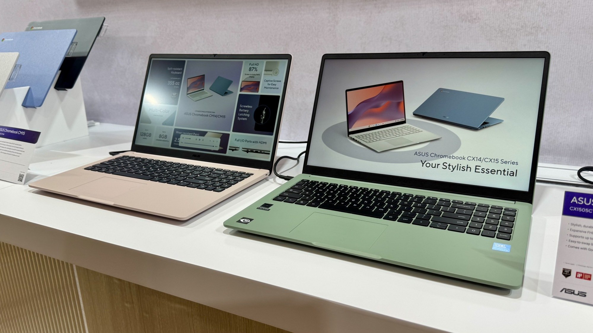 Two laptops, one green, on a desk
