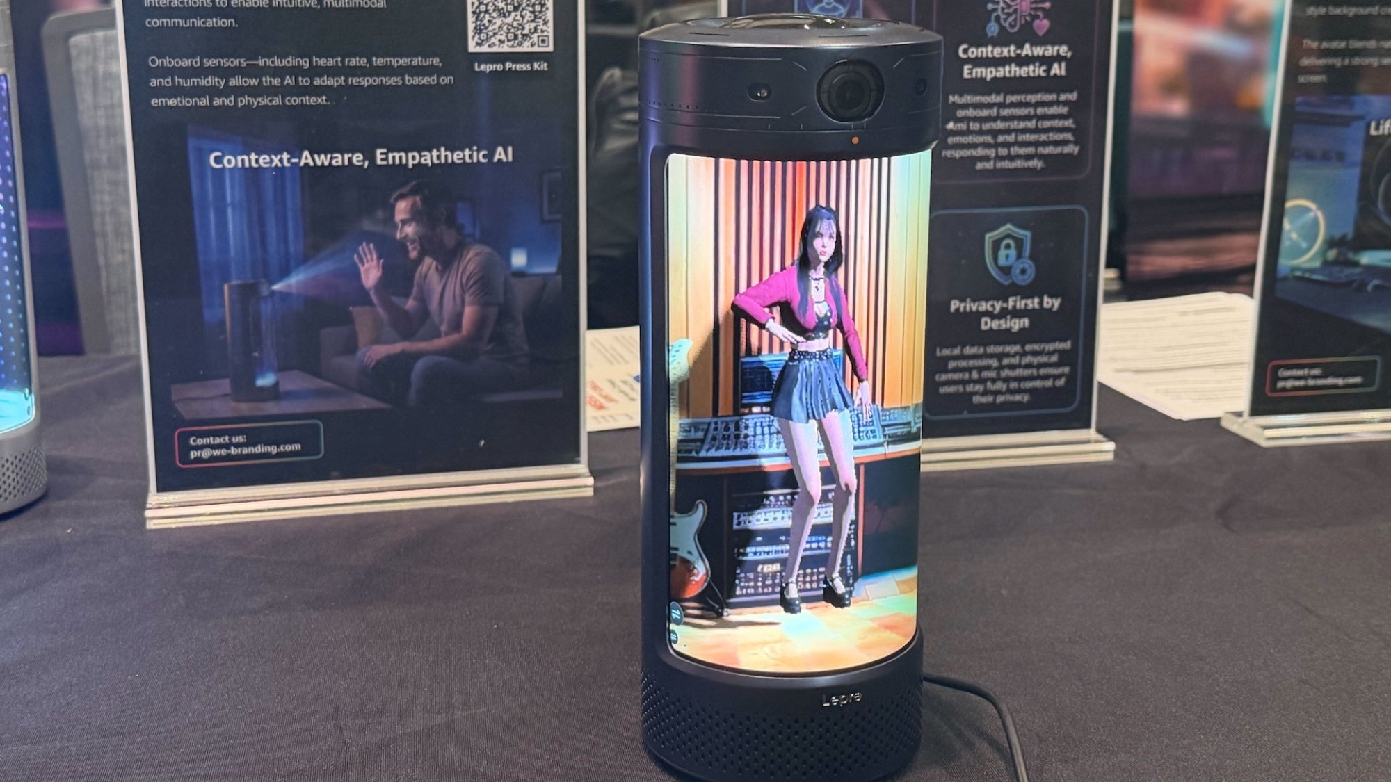 Holodeck of 3D-generated woman in a small tublar object.